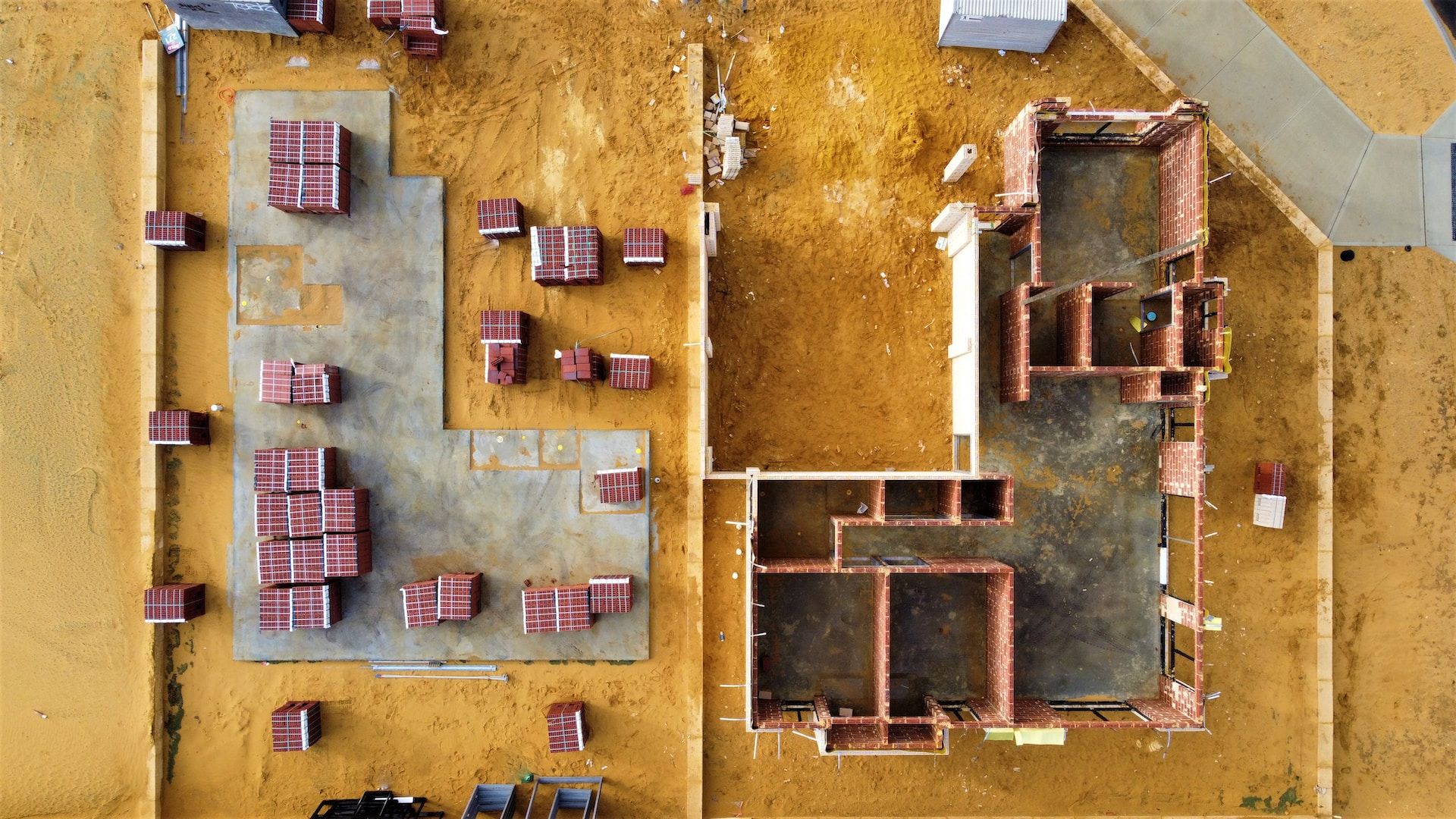 Air view of a building construction where the first wall foundations are visible